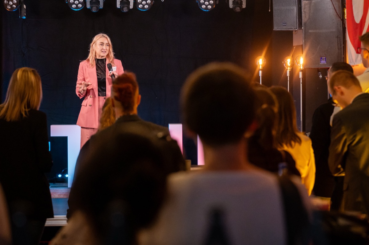 Katie Payne, founder of OhMyV, presenting on stage